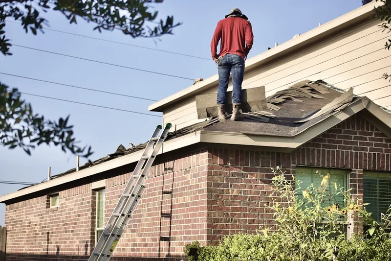 Professional roofer working on a residential roof in Mill Creek Park